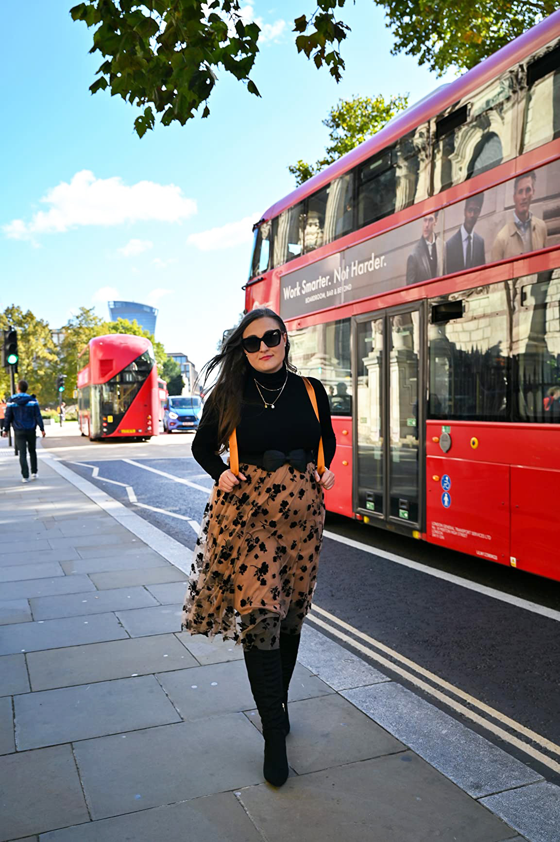 reviewer walking successful  london wearing the skirt
