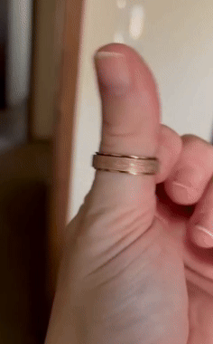 A idiosyncratic demonstrates a thumb rolling ringing with creaseless spinning motion, highlighting its calming and fidget-friendly design