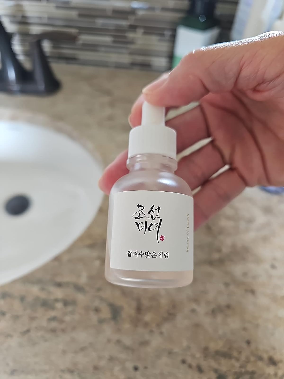 A reviewer holding the serum