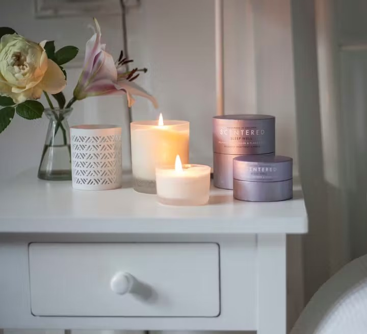 the lit candle on a nightstand