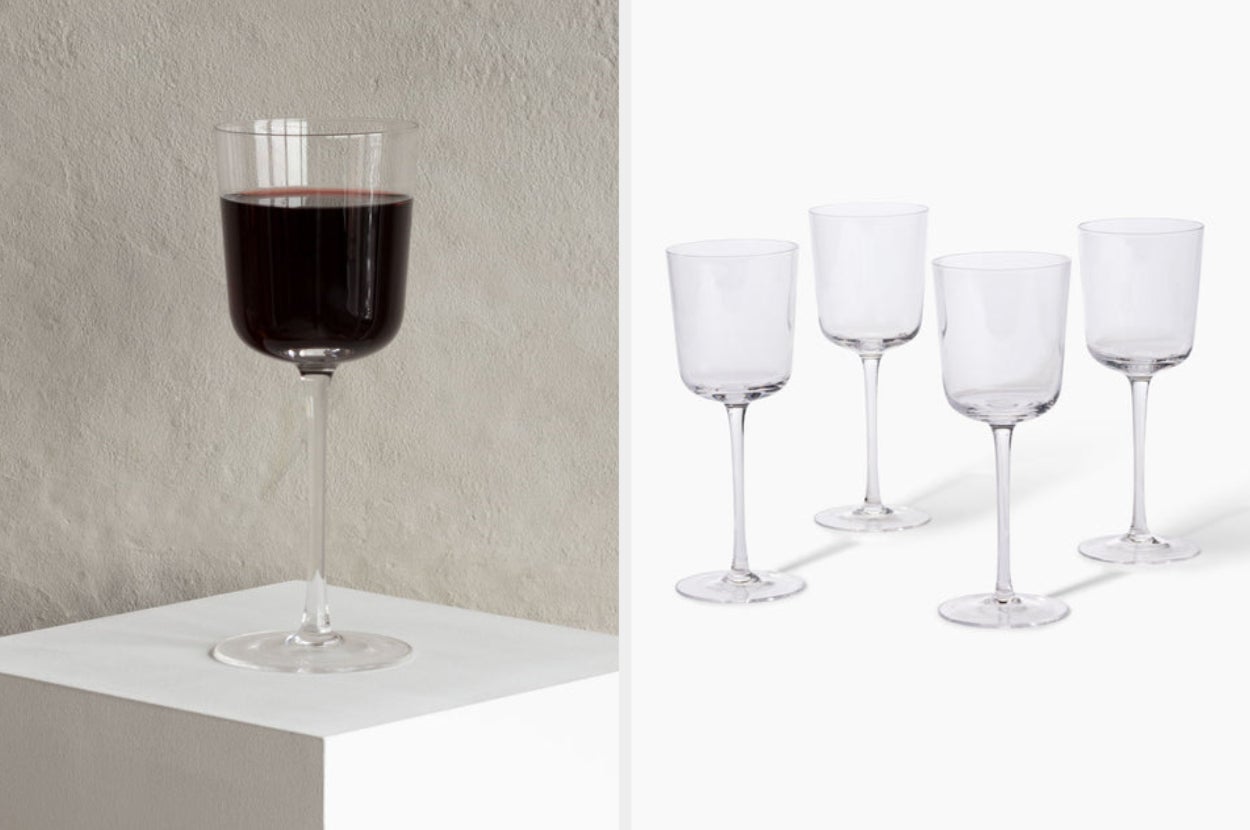 Image of single glass of red wine and four empty wine glasses