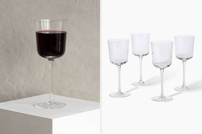 Image of single glass of red wine and four empty wine glasses