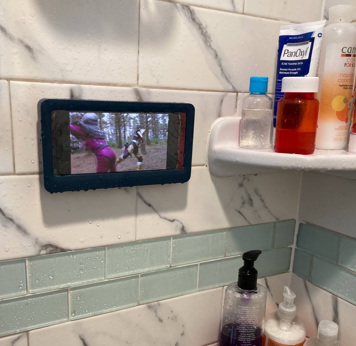 reviewer photo of the phone holder holding a phone in a shower