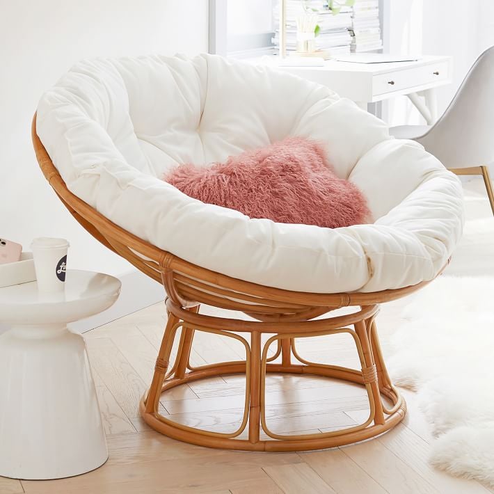 Image of brown chair with white and pink cushions