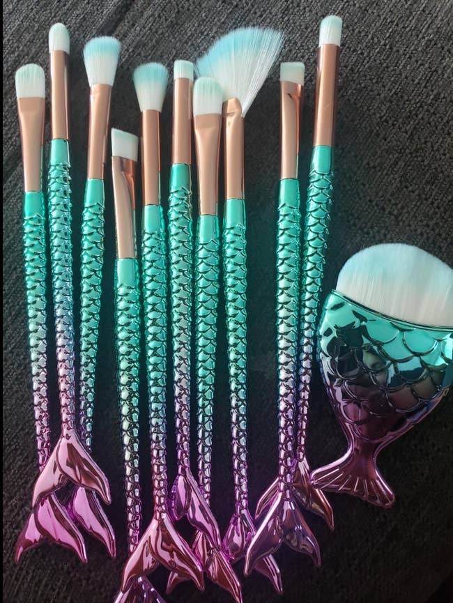 reviewers blue and purple ombre makeup brushes shaped like mermaid tails with white and blue bristles 