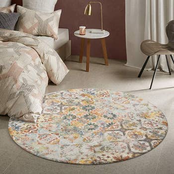 the round abstract floral area rug in a bedroom