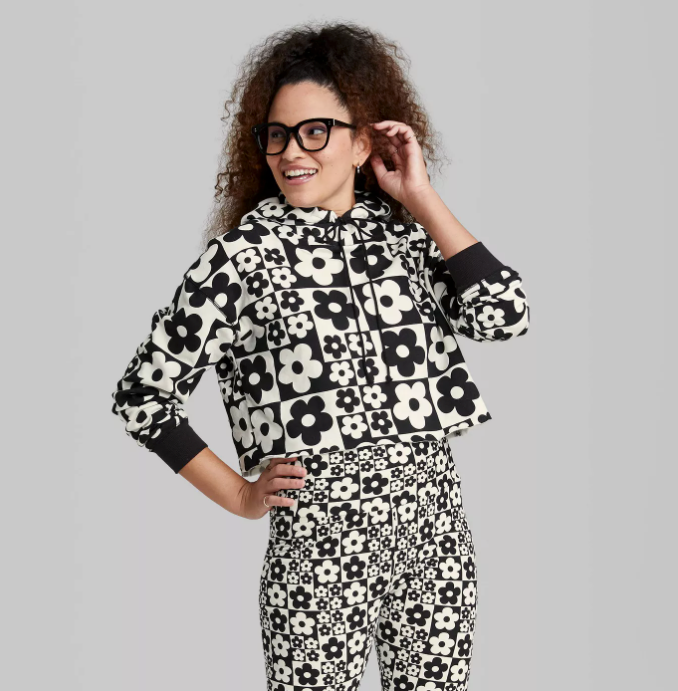 a model wearing a black and white sweatshirt with black and white florals all over it