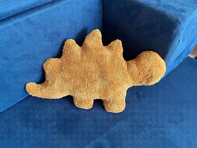 dino nugget pillow on reviewer's couch