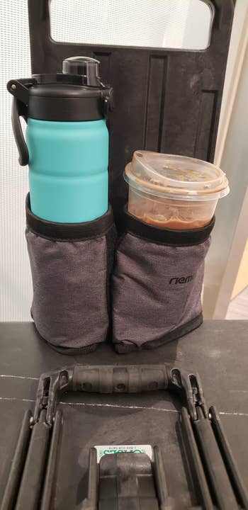 Reusable water bottle and food container in travel bag holder, ideal for organized, eco-friendly on-the-go storage solutions