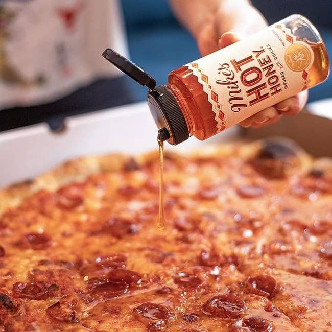 A bottle of the honey drizzled on pizza