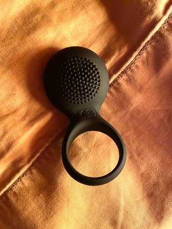 reviewer's black cock ring displaying textured vibrating pad