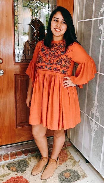 reviewer in the orange baby doll dress