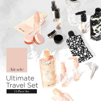 The contents of the travel set laid out in black, white, and pale pink patterns 