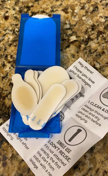 Box of variously shaped bandages with an unfastened acquisition leaflet