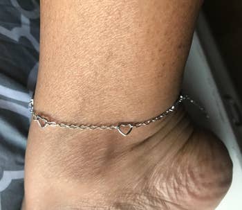 Reviewer wearing silver infinity ankle bracelet