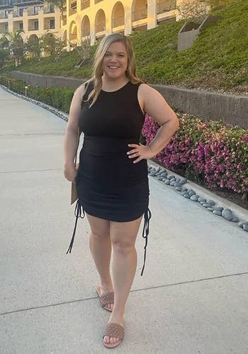 a reviewer posing in the black dress