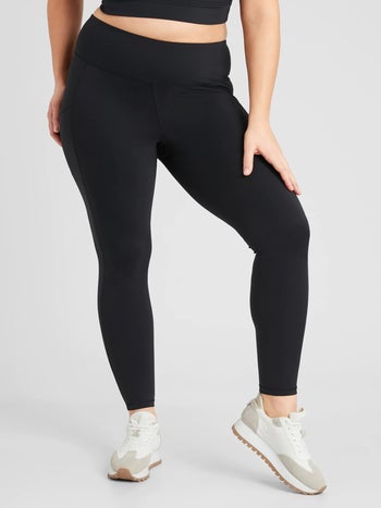 a model wearing pocketed black workout leggings