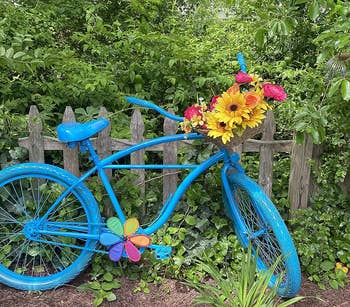 a bicycle planter that's been given a blue coat