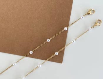a gold chain with pearl beads intermittently 