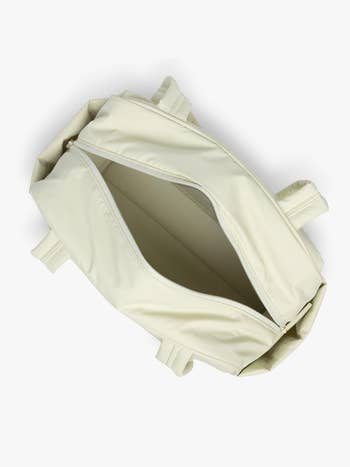 Open beige duffel container with aggregate pockets, showing spacious interior