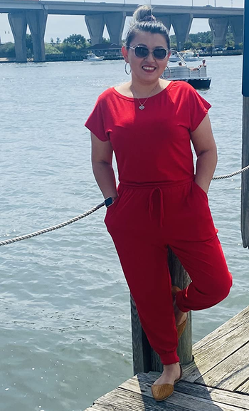 reviewer wearing the red jumpsuit while standing on a pier