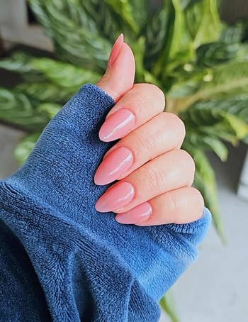 reviewer with nude pinkish nails