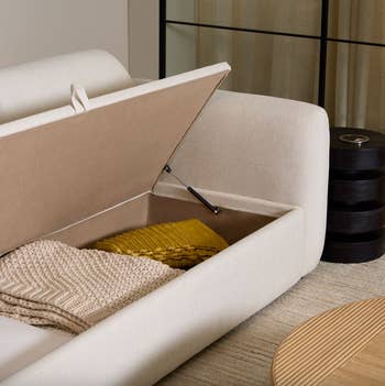 sofa with the seat lifted up to reveal storage