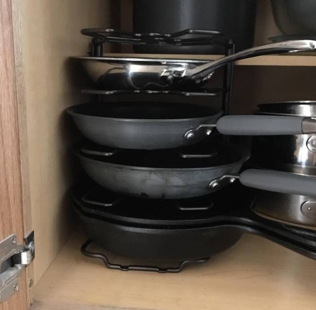 reviewer photo of pans neatly organized vertically on the pan rack