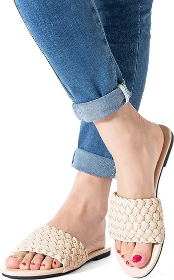 model in white braided slides