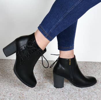 Image of reviewer wearing black lace accent booties