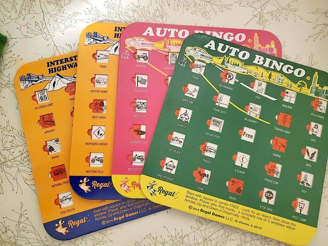 Four colorful Auto Bingo game cards depicting various travel-themed icons and words for a fun road trip activity