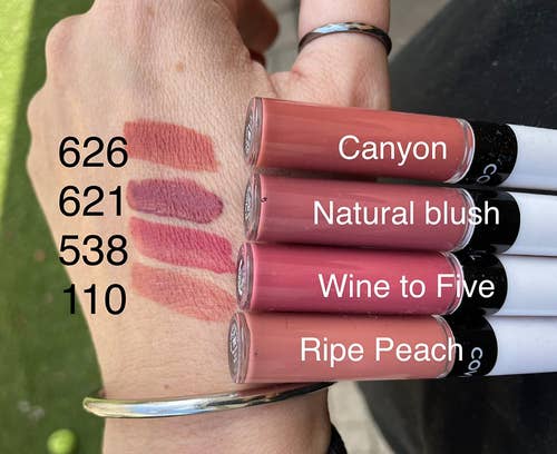 reviewer showing swatches of four lipstick shades on their hand