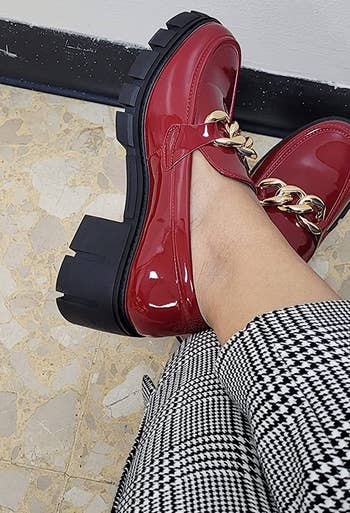 reviewer's feet in the red loafers