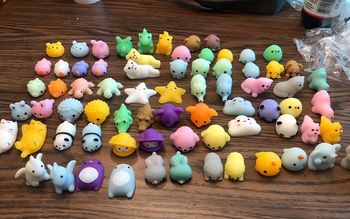 The mini toys all unwrapped and laid out on a table in various colors and shapes