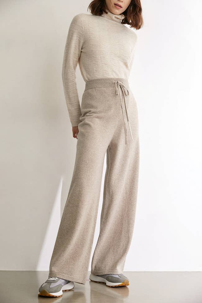 a model wearing the relaxed-fit wool pants with a drawstring waist 