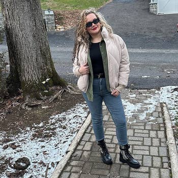 reviewer wearing the waist length jacket in a light khaki