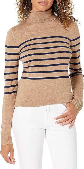 model in the camel and navy striped turtleneck sweater