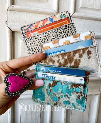 model holding three hair-on cowhide card holder wallets