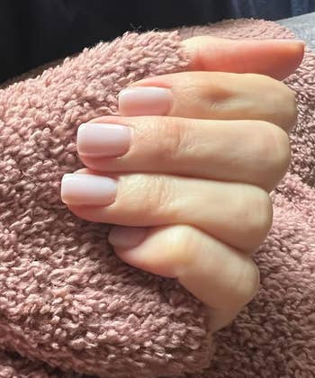 A close-up of a hand with neatly manicured nails