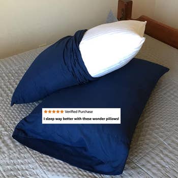 Two pillows on a bed, with a positive review overlay: 
