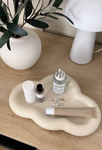 reviewer's unreality tray with jewelry, lipgloss, and perfumes connected it