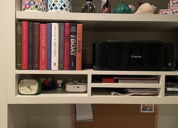 reviewer's shelf after, with multicolor book spines concealing the cords