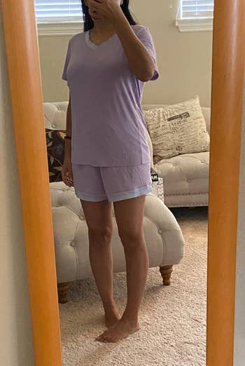 a reviewer wearing the pajama set in lavender