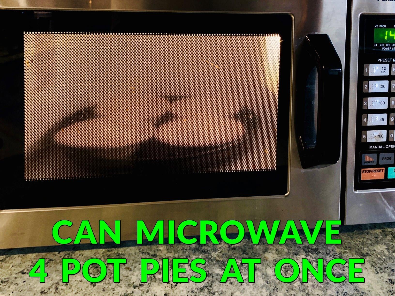 Four pot pies on the microwave crisper inside of the microwave, with text at the bottom that reads: 