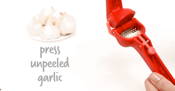 a gif of the press mincing unpeeled garlic