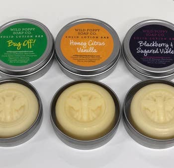 three different lotions with bee designs