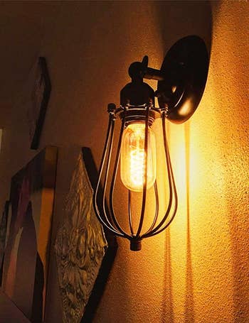 The bulb in a light fixture attached to a wall