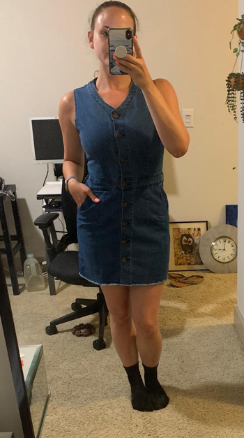 Reviewer wearing blue mini dress