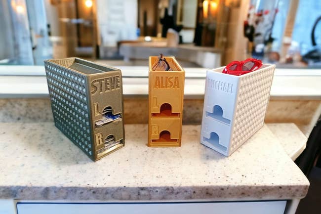 Three eyeglass holders labeled