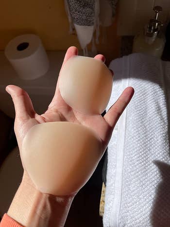 reviewer holding their silicone pasties in their hand